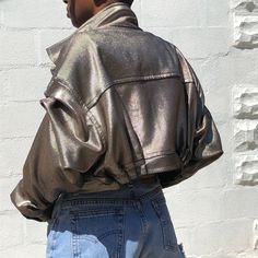 James Dean Inspired crop bicker jacket with a futuristic modern metallic fabric. This piece is 1 of 1, other sizes must be ordered -Metallic Painted Corded Fabric -2 front patch pockets -Lapel notch collar -Pleated sleeve and waist -Epaulette cuff -Dry clean only (can be hand washed gently) -Steam only (no Hot iron) Trendy Metallic Fitted Outerwear, Trendy Fitted Metallic Outerwear, Metallic Fitted Outerwear In Trendy Style, Trendy Metallic Outerwear For Fall, Metallic Fitted Long Sleeve Outerwear, Chic Metallic Outerwear For Night Out, Futuristic Fall Outerwear With Pockets, Metallic Outerwear With Pockets For Fall, Metallic Fitted Outerwear For Fall