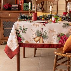 a christmas table cloth with holly and bells on it is sitting in front of a chair