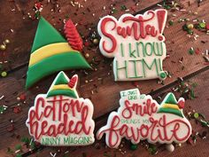 three decorated cookies sitting on top of a wooden table