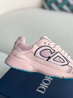 Embrace a playful and sporty aesthetic with these Dior B30-inspired sneakers in a soft pink hue. These eye-catching shoes, crafted with breathable mesh and technical fabric, are perfect for those who want to make a statement. The lightweight construction and sculpted rubber sole ensure all-day comfort and support, while the signature "CD" logo adds a touch of Dior's iconic style. Whether hitting the gym or the streets, these sneakers will elevate your look with a pop of color and undeniable conf Functional Pink Sneakers With Round Toe, Pink Breathable Sneakers For Athleisure, Pink Breathable Athleisure Sneakers, Pink Athleisure Sneakers For Running Errands, Functional Pink Low-top Sneakers, Pink Breathable Sneakers For Jogging, Functional Pink Sneakers For Light Sports, Pink Mesh Sneakers For Running Errands, Pink Dynamic Sneakers With Round Toe