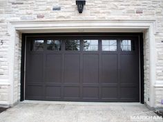 an overhead garage door is shown in front of a brick building