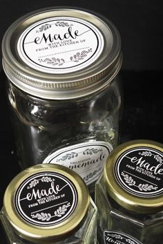 three jars with labels on them sitting next to each other in front of a black background