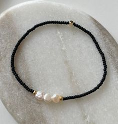 ♡ Florence ♡ Bracelet - Statue is not included, this listing is for the bracelet only - Very dainty and elegant beaded bracelet with Freshwater pearls. Please bear in mind that all Freshwater Pearls have unique shapes and sizes, no two pearls look the same. ♥ Small matt black beads ♥Three gold plated beads ♥ three small Freshwater pearls ♥ Stretchy cord so you can easily put it on and take it off ↠ All my jewellery is handmade by me in the U.K ↠ I will ship next day where possible except for wee Elegant Beaded Bracelets With Letter Beads For Jewelry Making, Elegant Heishi Bead Bracelets With Tiny Beads, Handmade Elegant Heishi Beads Bracelets, Elegant Round Beaded Bracelets With Letter Beads, Elegant Adjustable Letter Beads, Everyday Pearl Beaded Bracelets, Black Beaded Pearl Bracelets, Everyday Beaded Pearl Bracelet, Black Pearl Bracelets With Round Beads