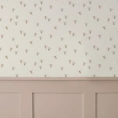 the wallpaper is white and has small flowers on it