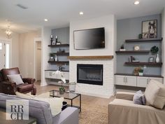 a living room with two couches and a television mounted on the wall above it