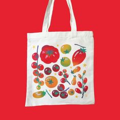 a tote bag with tomatoes and other vegetables on it, against a red background