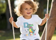 Your kids are going to love this super soft and fun "D is for Dinosaur" tee.  * Our modern unisex fitted shirt style features a crewneck and contoured side seams for a stylish trendy t-shirt. * All our tees and body suits come with a tear-away label for a scratch-free wearing experience * White shirts and bodysuits are 100% ringspun cotton. Heather color (grey) is  52% cotton, 48% polyester. Please make sure you check our size cards before you place your order.   If you have any questions please let us know. We hope to earn your business.  Thank You D Is For Dinosaur, Animals Alphabet, Dinosaur Tee, Dinosaur Shirt, Body Suits, Fitted Shirt, Animal Alphabet, Animal Shirts