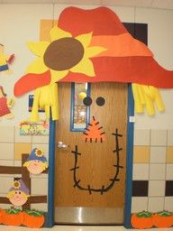 an image of a door decorated like a scarecrow with a sunflower on it