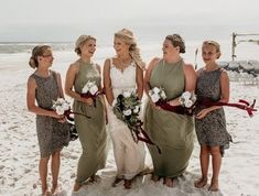 a group of women standing next to each other on top of a snow covered beach