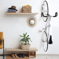 there is a bike mounted to the wall next to a shelf with shoes on it