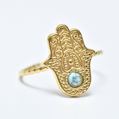 "Hamsa Ring, Blue Stone Hamsa Ring, Hamsa Ring, 18K Gold Ring, Adjustable Ring, Evil Eye Ring, Gold Filled, Stackable Ring, Gift for Her, Gift for Wife. Free international shipping Hamsa ring inlaid with  blue stone in 18K gold plating, the ring is designed in the shape of  classic hamsa. The pendant in the shape of hamsa eye is studded with special stone. Hamsa ring is  symbol of protection against the evil eye. She is  symbol of protection, good luck and spirituality. This ring is  perfect gift for anyone you want to protect. The stone embedded in the ring is  symbol of light and resurrection. It is considered  symbol of hope, happiness and protection. Add these simple yet stylish rings to your collections, bold and confident. They really go with everything!! ∙ Metal type: 18K gold plati Gold Turquoise Stackable Ring, Gold Turquoise Ring Gift, Gold Turquoise Ring For Gift, Adjustable Gold Turquoise Gemstone Ring, Adjustable Gold Turquoise Ring In Spiritual Style, Adjustable Gold Spiritual Turquoise Ring, Dainty Gold Turquoise Ring, Adjustable Gold Turquoise Ring For Wedding, Gold Brass Crystal Ring For Gifting