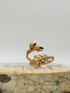 Gold Acorn with Oak Leaves Adjustable Ring - Acorn Ring, Fall Rings, Oak Leaf, Adjustable Ring, Symbolic Jewelry, Oak Branch Ring. ✦The ring is gold bronze and adjustable. **PLEASE NOTE: THIS LISTING IS ONLY FOR ONE RING.**  Sterling silver available below https://www.etsy.com/listing/1606720975/sterling-silver-acorn-with-oak-leaves?click_key=a838a137135e29172b9589dd7aea42a06908e6ea%3A1606720975&click_sum=e434e2a0&ref=shop_home_active_13&pro=1&sts=1 🎁Comes ready to gift in a gift box or bag. ❤️ Acorn Ring, Oak Leaf Jewelry, Oak Branch, Acorn And Oak, Fall Rings, Branch Ring, Book Jewelry, Symbolic Jewelry, Oak Leaves