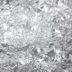 the texture of ice is shown in this black and white photo, as well as snow flakes