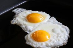 two fried eggs in a frying pan