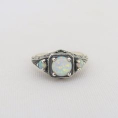 Vintage Sterling Silver White Opal Three stone Filigree Ring ....Marked 925....Total of weights 2.4grams...Size 9...Measure of Face 9MM...It's in very good condition. Classic Multi-stone Opal Jewelry, Classic Opal Multi-stone Jewelry, Antique Three Stone Round Jewelry, Antique White Multi-stone Rings, Classic Three Stone Oval Opal Ring, Vintage Sterling Silver Opal Ring, Vintage Round Sterling Silver Opal Ring, Sterling Silver Heirloom Opal Ring, Heirloom Sterling Silver Opal Ring