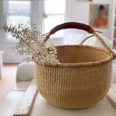 a wicker basket sitting on top of a wooden table