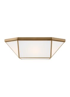 a light fixture on a white wall with a gold frame and frosted glass shades