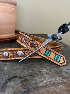 "This children's belt is handmade and will last a lifetime. Hand cut and tooled, stained with saddle tan. It has been sealed with a water resistant sealer to protect it from everyday wear and tear. This belt is sewn with reinforced threads and edge stitched for extra durability and strength. Listing is for belt only. Buckle is not included. Pick your initials and color and your new belt will be made just for you! If you wish to have a personal brand design instead of initials, please send me a m Personal Brand Design, Kids Tool Belt, Gait Belts, Custom Belts, Leather Obi Belt, Leather Tool Belt, Custom Leather Belts, Cowgirl Belts, Tooled Leather Belts