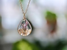 This necklace features Gladiolus, the birth flower for August, carefully preserved in a clear resin pendant. Gladiolus is symbolic of strength of character, faithfulness, moral integrity, and remembrance, making this necklace a perfect personalized birthday gift. Material: 14k gold filled chain and components or Silver, Resin Flower: Real Pressed Flower Chain Length: 18" (45cm)  Pendant Width: 0.79" (2cm) Pendant Height: 0.98" (2.5cm) Every pieces is made by hand and unique, therefore each piece Spiritual Necklaces With Pressed Flowers As Gift, Birthday Jewelry With Pressed Flowers, Spiritual Style Necklace With Pressed Flowers As A Gift, Birthday Flower Jewelry With Pressed Flowers, Birthday Flower-shaped Jewelry With Pressed Flowers, Round Pressed Flowers Jewelry For Birthday Gift, Birthday Flower Pendant Necklace With Pressed Flowers, Spiritual Clear Jewelry Gift, Spiritual Style Clear Jewelry For Gift