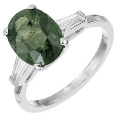 an oval green tourmaline and baguette diamond ring