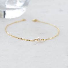 A beautiful and elegant dainty freshwater pearl bracelet. This bracelet is great for stacking or worn on its own for a delicate and minimalist look! Also makes a great gift for bridesmaids! Made of 925 Sterling Silver THICK plating of 14k Gold or Rhodium for a piece that is made to last! Available in 6.25" or 6.75" + .5" extension chain Made of freshwater pearls Nickel-free & Hypoallergenic Pearl Size: 3.5mm Lobster Clasp Closure Dainty Pearl Drop Bracelet, Dainty Pearl Drop Jewelry, Elegant Pearl Drop Chain Bracelet Gift, Delicate Pearl Drop Bracelet For Formal Occasions, Adjustable Minimalist Pearl Bracelet, Dainty Pearl Bracelet For Formal Occasions, Minimalist Adjustable Pearl Chain Bracelet, Minimalist Adjustable Pearl Bracelet, Pearl Drop Bracelets For Bridesmaids