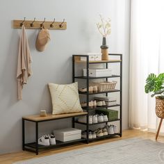 a shoe rack with shoes on it next to a window and a potted plant