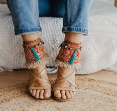 These Boho Sandals Ankle Belts will help you to completely transform any basic sandal into something stylish and unique. They are made with carefully selected ethnic materials, in a completely handmade process. With them, you will get those sandals that you wear everywhere and have super comfortable, have a different air when you want. In this way, you can enhance that Boho-Chic style that we love so much. This ad is for a pair of anklets, footwear is not included. If you need a custom design or for a girl, do not hesitate to write to me and we will design it together. The anklets are adjustable to fit a variety of widths. Handmade design Made with multicolored trimmings, and natural color fringes and aqua green tassel Adjustable leather straps Measurements for decorative part of the ankle Bohemian Adjustable Anklets, Bohemian Ankle Wrap Sandals For Spring, Bohemian Ankle-wrap Sandals For Spring, Spring Festival Multicolor Anklets, Bohemian Anklets For Vacation In Spring, Bohemian Anklets For Spring Vacation, Bohemian Handmade Festive Anklets, Bohemian Sandals With Tassels And Adjustable Straps, Bohemian Anklets For Beach In Spring