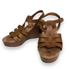 Style Name: Pleasing Color: Cognac Shoe Type: Wedge Platform: Yes Heel Height: 4” Condition: New, Unused Materials: Manmade Closure: Buckle Inner Sole: Memory Foam Made In China Casual Leather Platform Wedge Sandals, Brown Platform Wedge Sandals With Round Toe, Brown Wedge Sandals With Heel Loop And Round Toe, Casual Closed Toe Wedge Sandals With Heel Loop, Casual Brown Wedge Sandals With Round Toe, Brown Wedge Sandals With Removable Insole, Brown Cushioned Wedge Sandals With Round Toe, Brown Cushioned Round Toe Wedge Sandals, Casual Brown Wedge Heel Sandals