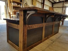 a kitchen island made out of wooden planks in a garage with an oven on top