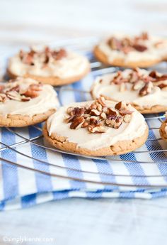 cookies with frosting and pecans on a cooling rack