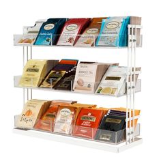 three tiered display with coffee bags and teas on the bottom shelf in front of white background