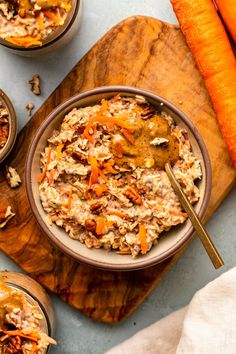 a bowl of carrots and oatmeal on a cutting board