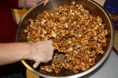 a person is mixing some kind of food in a bowl on the stove top with a spatula