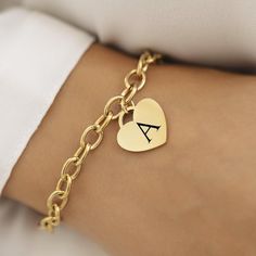 Introducing our 18k Disc Gold Plated Initial Bracelet--a perfect blend of elegance and personal flair. This stunning bracelet features a delicate heart pendant, measuring 20mm x 20mm, crafted from 18k gold-plated stainless steel. Whether you're treating yourself or finding a special gift, this piece combines timeless charm with modern durability. This bracelet is not only a stylish accessory but also practical. It's waterproof and hypoallergenic, making it a great choice for everyday wear. The 1 Rose Gold Charm Bracelet As A Gift, Classic Heart Charm Bracelet For Wedding, Rose Gold Charm Bracelet For Gift, Elegant Everyday Heart Bracelet With Charms, Elegant Heart-shaped Charm Bracelet For Weddings, Everyday Yellow Gold Heart Charm Bracelet, Elegant Stainless Steel Heart Bracelet For Anniversary, Classic Wedding Heart Charm Bracelet, Elegant Heart-shaped Wedding Charm Bracelet