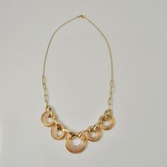 A fine hand made 1940s high art deco necklace in rose and yellow gold. This divine necklace features a central hand made focus that is hand crafted in rose and yellow gold. The design is exceptionally streamlined. The necklace measures 17" long and is 13/16" wide (432mm x 20mm). Made from fine 14K rose and yellow gold it weighs a total of 23.19 grams. It is in excellent condition.This is a one of a kind original art deco necklace not a reproduction item in the deco style. An appraisal shall acco Art Deco Round Necklace For Anniversary, Rose Gold Round Necklace With Gold Chain, Rose Gold Necklace With Round Gold Chain, Rose Gold Necklace With Gold Chain, Art Deco Necklace For Anniversary, Vintage Gold-plated Jewelry With Delicate Chain, Art Deco 14k Rose Gold Jewelry, Art Deco Yellow Gold Jewelry For Jewelry Making, Rose Gold 14k Art Deco Jewelry