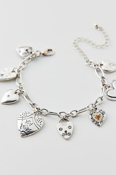 Vintage-inspired charm bracelet trimmed with a mix of heart-shaped charms. Choose from a silver or gold bracelet. Features Kyla heart charm bracelet Vintage-style charm bracelet Adjustable length Content + Care Mixed metal, glass Avoid contact with water Imported Size Dimensions: 7.5" l + extender | Kyla Heart Charm Bracelet in Silver, Women's at Urban Outfitters Charm Bracelet Aesthetic, Urban Outfitters Jewelry, Bday Gift, Bracelet In Silver, Vintage Charm Bracelet, Silver Charm Bracelet, Bracelet Vintage, Christmas 2024, Mixed Metals