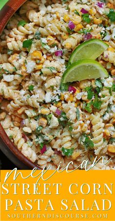 mexican street corn pasta salad in a bowl with cilantro and lime on top