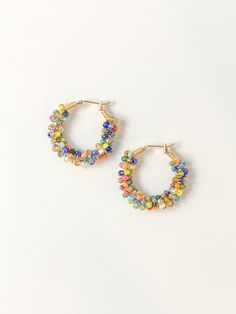 Make a statement with our signature Angler Hoops - hand-beaded and ready to add a bold splash of color to your look. These vibrant, handcrafted pieces will have you hooked! Now, the only question remaining is: how many hues will you choose? Due to the handmade nature of these earrings, expect small variations and imperfections that make your pair unique. Trendy Handmade Hoop Beaded Earrings, Multicolor Circular Summer Earrings, Multicolor Hoop Earrings For Summer, Trendy Small Hoop Beaded Earrings, Multicolor Round Earrings For Summer, Trendy Colorful Jewelry With Large Beads, Colorful Beads Hoop Earrings For Party, Colorful Beads Hoop Earrings, Handmade Hoop Beaded Earrings For Party