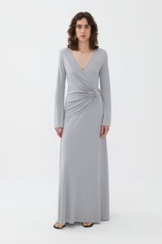 Nocturne dresses up this long dress with a front accessory details, creating a double-breasted dress suitable for celebrating festive events with unfettered style.V-neck, long sleeve, double-breasted dress with accessory details. Dry clean Material: 56% Viscose, 34% Nylon, 10% Elastane Long Sleeve Officially licensed Imported Brand: Nocturne Model Product Size: S Model Size: Height 5'10 / Bust 29.5 in / Waist 23 in / Hips 34 in True the size Elegant V-neck Dress For Dinner, Elegant Fitted V-neck Dress For Dinner, Evening Gown With V-neck In Dressy Style, Chic Long V-neck Formal Dress, V-neck Maxi Dress For Evening Gala, Chic Formal V-neck Gown, Luxury V-neck Maxi Dress For Gala, Dressy V-neck Dress With Surplice Neckline For Evening, Elegant Long V-neck Party Dress