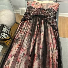 This Is A Brand New Marchesa Notte Gown That Has Never Been Worn. It Is A Size 2, But The Lower Half Is Forgiving If You Carry More Weight On Your Bottom Half. I Am A Size 8/10 And 5’7. The Dress Cannot Zip Closed On Me But It Fits My Bottom Half Perfectly Fine. It Drags On The Floor For My Height So It Would Accommodate Those Taller Than Me. The Dress Has No Imperfections And Is In Brand New Condition. I Bought It A Few Years Ago But I Grew Out Of It Before I Could Ever Wear It. Let Me Know If Floor-length Lace Gown With Lined Bodice, Strapless Lace Maxi Dress For Formal Occasions, Evening A-line Gown With Lace Bodice, Black Lace Trim Floor-length Gown, Black Floor-length Gown With Lace Trim, Spring Evening Gown With Lace Bodice, Black Floor-length Evening Dress With Lace Trim, Black Lace Trim Floor-length Evening Dress, Evening Maxi Gown With Lace Trim