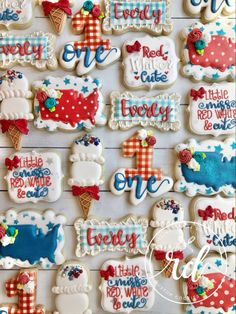 decorated cookies are displayed on a white board with red, white and blue icing