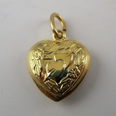 "This sterling silver, two-sided, repousse Puffy Heart Charm Number 3 features two hearts attached with cupid's arrow surrounded by flowers and foliage. Marked, Sterling. Made by Brown County Silver. Vintage and in new, never worn condition. Approximately 30 years old. Available in antiqued silver and gold vermeil. 3/4\" high with jump ring 1/2\" wide 1.1 grams approx. *Chain sold separately See more @ https://www.etsy.com/shop/brocosi" Collectible Heart-shaped Hallmarked Jewelry, Collectible Heart-shaped Jewelry For Valentine's Day, Valentine's Day Heart Charm Jewelry Collectible, Valentine's Day Collectible Jewelry With Heart Charm, Valentine's Day Collectible Heart Charm Jewelry, Anniversary Heart Necklace With Double Heart Charms, Hallmarked Heart Necklace For Valentine's Day, Cupid Heart, Necklace Girlfriend