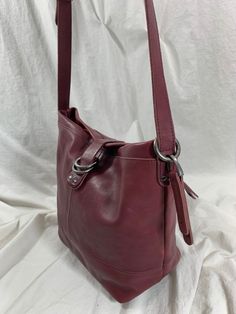 "Measurements are 11\"5 top wide, 9\"7 high, 5\"5 deep with one 40\"5 shoulder strap with a 19\" drop. On the interior there is one main compartment with a back zipper pocket, two back pockets, lined in tan fabric and a front magnetic closure. The color of leather is between grape and burgundy with dark silver tone hardware, exterior pocket for easy to access items and bag is well cared for. Lovely vintage bag with great detail and perfect for daily use. ----------------------------------------- Burgundy Purse, Tan Fabric, Vintage Bag, Leather Bucket, Red Suede, Vintage Bags, Bag Straps, New Bag, Dooney Bourke