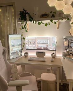 a computer desk with two monitors and a stuffed animal on the chair next to it