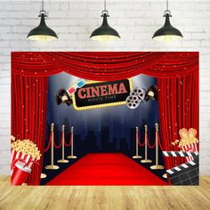 an image of a red carpeted stage with curtains and popcorn buckets on it