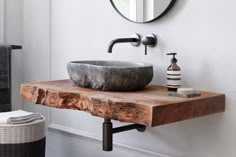 a bathroom sink sitting on top of a wooden counter