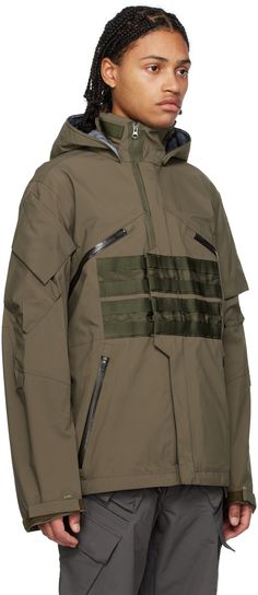 Gore-tex ePTFE-coated nylon taffeta jacket. Water-repellent, wind-resistant, and breathable. · Paneled construction · Bungee-style drawstring at detachable hood · Half and full zip closure · Webbing detailing with press-stud placket · Zip pockets · Concealed bungee-style drawstring at hem · Storm flap and patch pockets at sleeves · Adjustable velcro cuffs · Locker loops at back · Off-set zip vent at back hem · Elasticized cinch-strap at interior · Full ripstop lining Supplier color: Raf green Acronym Clothing, Taffeta Jacket, Detachable Hood, Press Studs, Gore Tex, Luxury Streetwear, Water Repellent, Patch Pocket, Zip Pockets