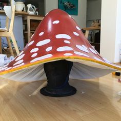 a mushroom shaped object sitting on top of a wooden table