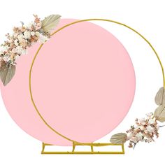 a pink circle with gold frame and white flowers on the top is surrounded by leaves