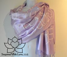 a purple and white scarf hanging on a wall